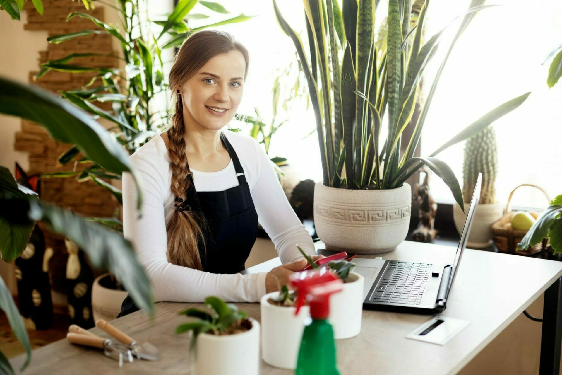 a-florist-girl-uses-a-laptop-while-working-at-a-flower-shop-and-takes-orders-online-small-business_t20_G03zn6